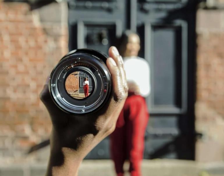 Focusing on a woman through a camera lens