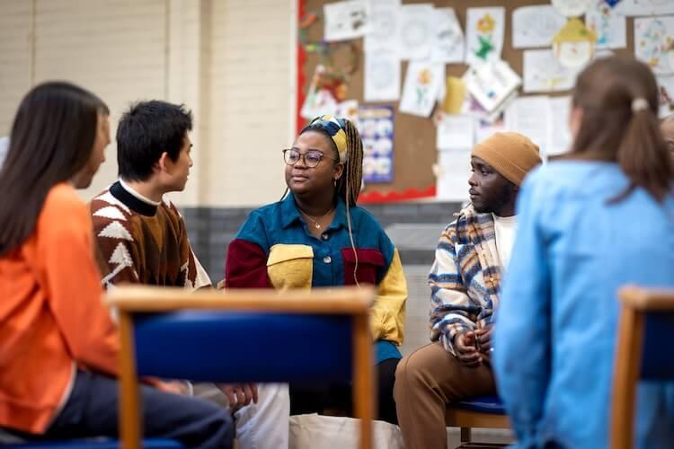 People of color talking around a table