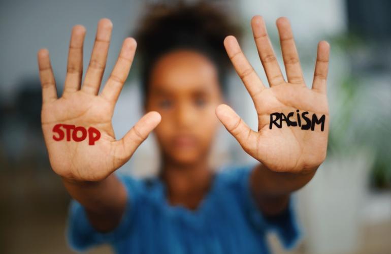 Hands written with 'Stop Racism'